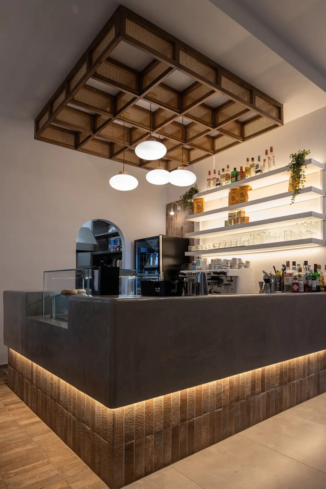 The coffee bar with shelves and drinks at Nami