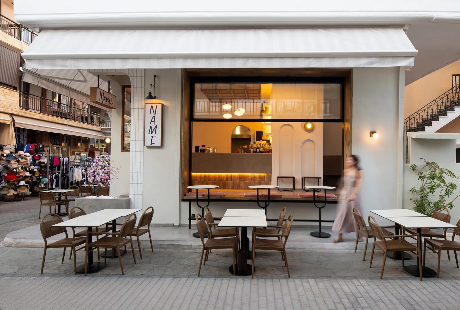 The Nami Brunch House storefront with white awnings and tables in Sarti